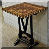 F32. Small carved side table with Egyptian decorations. 21”h x 15”w x 15”d 